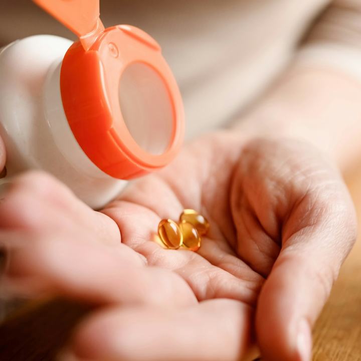 Girl take pills with dietary supplement and vitamins.