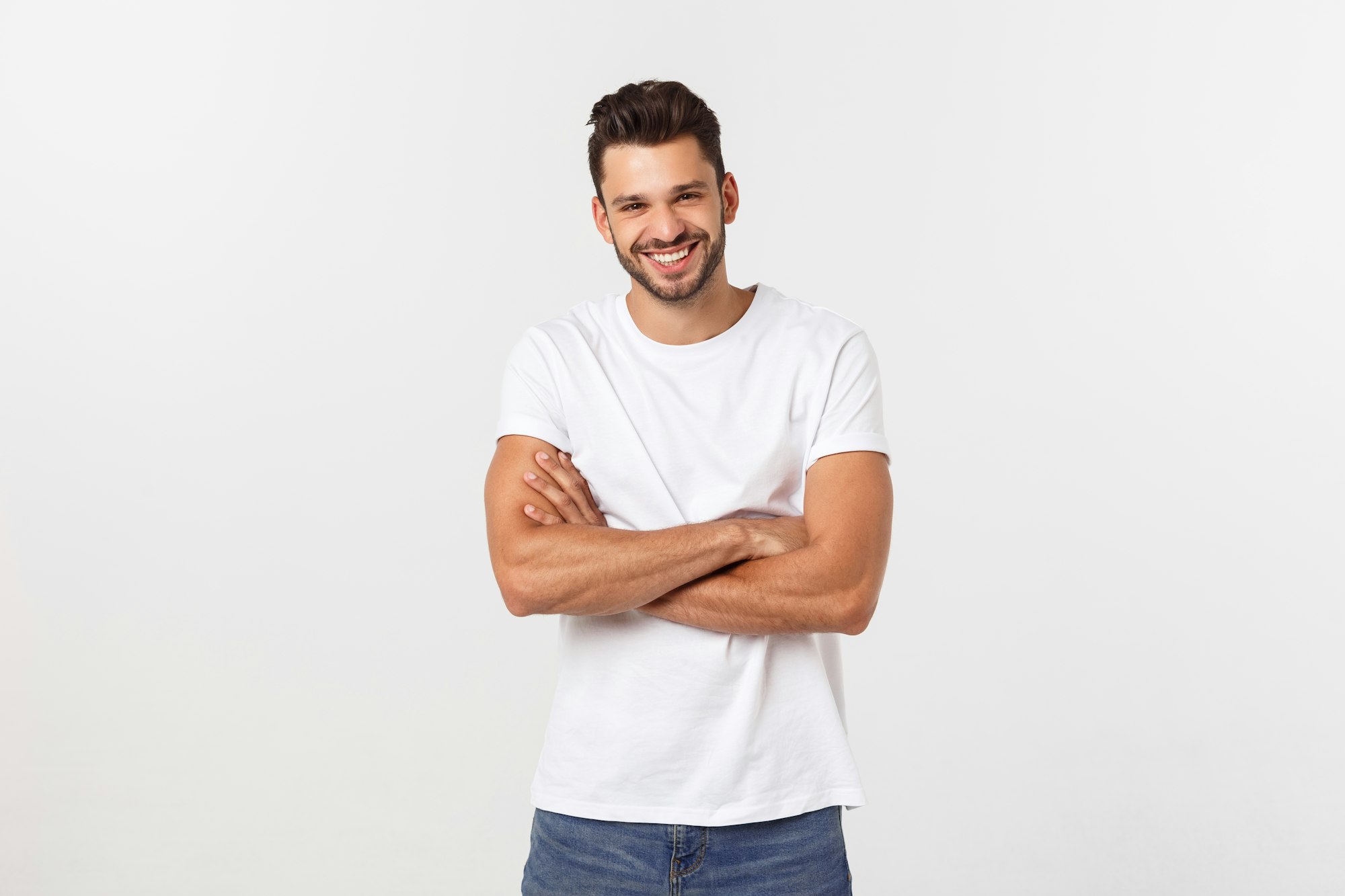 Portrait of a handsome young man smiling against white background